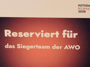 Schild: Weißer Text auf roten Hintergrund: Reserviert für das Siegerteam der AWO.