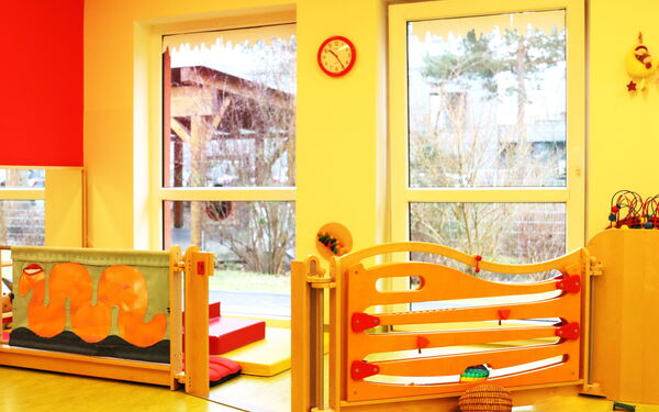 Teil eines hellen Raums. Spielzimmer für kleine Kinder, zwei Holzelemente zum Spielen.