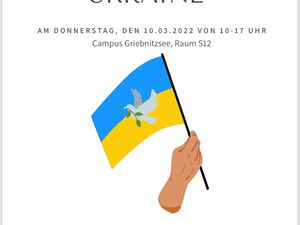 Eine Hand hält die ukrainische Fahne