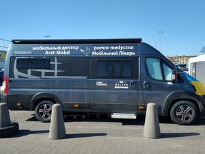 Ein Transporter neben einem Zelt