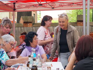 Tisch an dem Frauen sitzen und sich unterhalten. Fröhliches Miteinander.